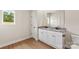 Modern bathroom featuring double sinks, granite countertops, and white cabinets at 7106 Jerimoth Dr, Charlotte, NC 28215