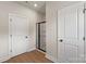 Modern bathroom features wood-look floors, black framed shower, and white doors at 7106 Jerimoth Dr, Charlotte, NC 28215