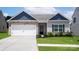 Charming single-story home featuring stone accents, a two-car garage, and well-maintained landscaping at 7106 Jerimoth Dr, Charlotte, NC 28215