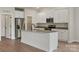 Modern kitchen with white cabinets, granite countertops, stainless steel appliances, and a center island at 7106 Jerimoth Dr, Charlotte, NC 28215