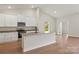 Bright kitchen with white cabinets, granite countertops, a center island, and stainless steel appliances at 7106 Jerimoth Dr, Charlotte, NC 28215
