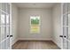 Bright office space with French doors, wood-look flooring, and a view of the outdoors at 7106 Jerimoth Dr, Charlotte, NC 28215
