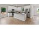 Kitchen with white cabinets, granite countertops, a central island, and stainless steel appliances at 7314 Jerimoth Dr, Charlotte, NC 28215