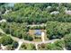 Aerial view of home surrounded by lush trees and landscaping, offering privacy and curb appeal at 738 Kemp Rd, Mooresville, NC 28117