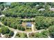 Aerial view of home surrounded by lush trees and landscaping, offering privacy and curb appeal at 738 Kemp Rd, Mooresville, NC 28117