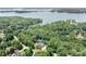Stunning aerial view of lake house nestled amongst trees with beautiful lake view, showing serene waterfront living at 738 Kemp Rd, Mooresville, NC 28117