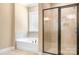 Bright bathroom features a soaking tub with jets and a glass-enclosed walk-in shower at 738 Kemp Rd, Mooresville, NC 28117