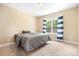 Bright bedroom with neutral carpet features a large window and blue and white curtains at 738 Kemp Rd, Mooresville, NC 28117