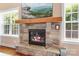 Stone fireplace with a wooden mantel and a TV above it at 738 Kemp Rd, Mooresville, NC 28117