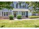 Inviting front entrance with gray siding, stone accents, and a charming covered porch at 738 Kemp Rd, Mooresville, NC 28117