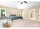 Spacious primary bedroom with a large bed, tray ceiling, and an ensuite bathroom at 738 Kemp Rd, Mooresville, NC 28117