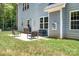 Outdoor patio with chairs, grill, and open backyard showcasing a great space for relaxation and entertainment at 738 Kemp Rd, Mooresville, NC 28117