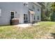 Back patio with chairs, grill, and view of the home and spacious green lawn at 738 Kemp Rd, Mooresville, NC 28117