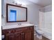 Bathroom featuring a wood vanity, framed mirror, and a shower-tub combination at 8115 Tremaine Ct, Charlotte, NC 28227