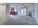 Open-concept living room flows into the kitchen, featuring a fireplace and sliding glass door at 8115 Tremaine Ct, Charlotte, NC 28227