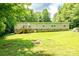 Spacious backyard with well-kept lawn and mature trees provides ample privacy and a peaceful setting at 812 Acclaim Dr, York, SC 29745