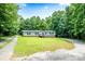 Charming single-story home with a covered front porch and a well-maintained lawn surrounded by mature trees at 812 Acclaim Dr, York, SC 29745