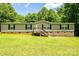 Single-story home with front-facing porch and yard, framed by mature trees on a sunny day at 812 Acclaim Dr, York, SC 29745