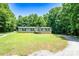Charming single-story home with a covered front porch and a well-maintained lawn surrounded by mature trees at 812 Acclaim Dr, York, SC 29745
