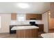 Well-lit kitchen featuring modern appliances, laminate counters, and wood cabinets at 812 Acclaim Dr, York, SC 29745