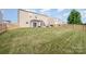 Expansive fenced backyard offers ample space with a patio, pergola, grill, and lush green lawn at 9822 Bayview Pkwy, Charlotte, NC 28216