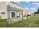 Spacious backyard features a patio with pergola, a grill, and a well-maintained lawn with privacy fence at 9822 Bayview Pkwy, Charlotte, NC 28216