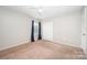 Bedroom featuring a ceiling fan, neutral carpet and large window at 9822 Bayview Pkwy, Charlotte, NC 28216