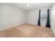 Well-lit bedroom with a ceiling fan, carpet, and large window at 9822 Bayview Pkwy, Charlotte, NC 28216