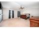 Spacious bedroom featuring a ceiling fan, a large window, and a warm carpet at 9822 Bayview Pkwy, Charlotte, NC 28216
