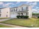 Two-story home with neutral siding, black shutters, an attached two-car garage, and a landscaped front yard at 9822 Bayview Pkwy, Charlotte, NC 28216