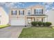 Two-story home with neutral siding, black shutters, a well-manicured lawn, and an attached two-car garage at 9822 Bayview Pkwy, Charlotte, NC 28216