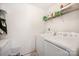 Bright laundry room features white appliances and convenient wire shelving for storage at 9822 Bayview Pkwy, Charlotte, NC 28216