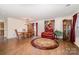 Bright living room and dining area features wood floors, stylish rug, and comfortable seating at 9822 Bayview Pkwy, Charlotte, NC 28216