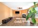 Spacious living room featuring a fireplace, a ceiling fan, a wall-mounted TV, and wood flooring at 9822 Bayview Pkwy, Charlotte, NC 28216