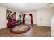 Living room showcasing wood flooring, a rug, an interesting art piece, and bright natural lighting at 9822 Bayview Pkwy, Charlotte, NC 28216