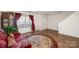 Bright living room featuring wood flooring, a window with curtains, and a red sofa at 9822 Bayview Pkwy, Charlotte, NC 28216