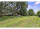 Sprawling backyard featuring a lush lawn, mature trees, and serene ambiance at 9954 Mitchell Glen Dr, Charlotte, NC 28277