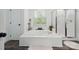 Bright bathroom features a soaking tub, walk-in shower with glass door, and a window letting in natural light at 9954 Mitchell Glen Dr, Charlotte, NC 28277