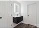 Modern bathroom boasts a floating vanity with illuminated mirror, sleek fixtures, and ample storage at 9954 Mitchell Glen Dr, Charlotte, NC 28277