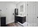 Modern bathroom with floating vanity, backlit mirror, and marble accent wall at 9954 Mitchell Glen Dr, Charlotte, NC 28277