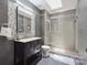 Updated bathroom with a glass shower, sleek vanity, and modern tile accents at 9954 Mitchell Glen Dr, Charlotte, NC 28277