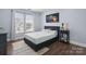 Cozy bedroom with hardwood floors and a large window that provides natural light at 9954 Mitchell Glen Dr, Charlotte, NC 28277