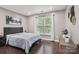 Relaxing bedroom with hardwood floors, neutral paint, and a window with natural light at 9954 Mitchell Glen Dr, Charlotte, NC 28277