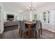 Bright dining area open to the living room with ample natural light and gray seating at 9954 Mitchell Glen Dr, Charlotte, NC 28277