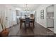 Cozy dining area with modern lighting, gray walls, and dark hardwood floors at 9954 Mitchell Glen Dr, Charlotte, NC 28277