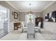 Elegant dining room features a glass table, white chairs, and decorative lighting at 9954 Mitchell Glen Dr, Charlotte, NC 28277