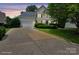 Charming two-story home with a well-manicured lawn and a spacious driveway leading to an attached two-car garage at 9954 Mitchell Glen Dr, Charlotte, NC 28277
