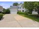 Charming two-story home with a well-manicured lawn and a two-car garage at 9954 Mitchell Glen Dr, Charlotte, NC 28277