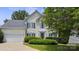 Charming two-story home with a well-maintained lawn, attached garage and dark shutters at 9954 Mitchell Glen Dr, Charlotte, NC 28277