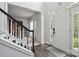 Welcoming foyer with staircase, hardwood floors, and view of the living room at 9954 Mitchell Glen Dr, Charlotte, NC 28277